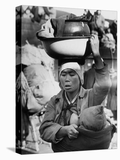 Korean Mother Nursing Her Baby, Carrying All Her Belongings in a Wash Basin, Retreating from Seoul-Carl Mydans-Stretched Canvas