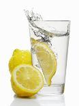 A Wedge of Lemon Falling into a Glass of Water-Kröger & Gross-Photographic Print