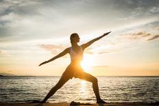 Full Length Side View of the Silhouette of a Fit Woman Practicing the Warrior Yoga Pose against Sky-Kzenon-Laminated Photographic Print