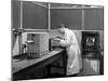 Lab Tachnician Using a Table Top Test Furnace, Sheffield, South Yorkshire, 1962-Michael Walters-Mounted Photographic Print