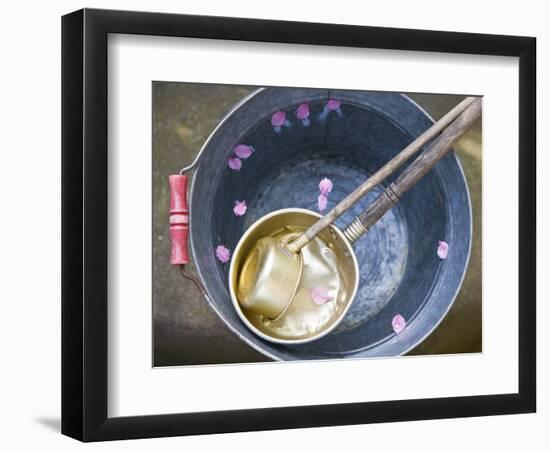 Ladling peach blossoms from a water pail-null-Framed Photographic Print