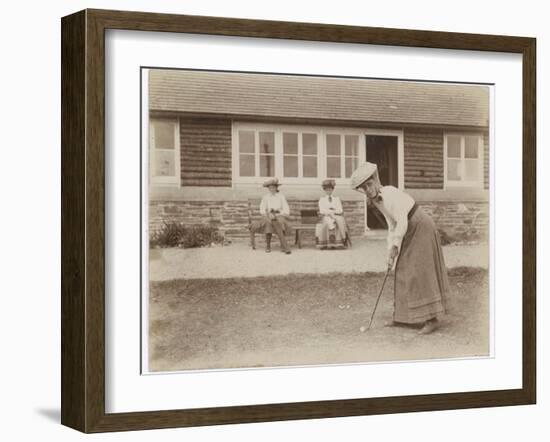 Lady Golfer Prepares to Putt as Two Seated Spectators Watch-null-Framed Photographic Print