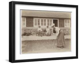 Lady Golfer Prepares to Putt as Two Seated Spectators Watch-null-Framed Photographic Print