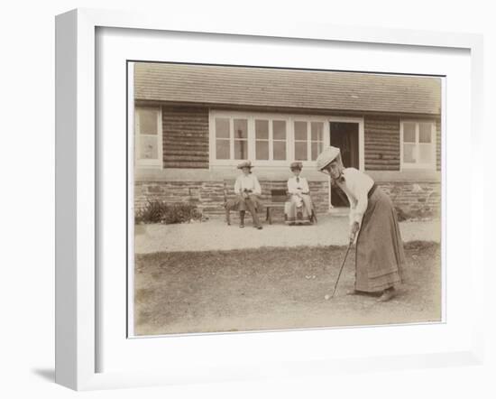 Lady Golfer Prepares to Putt as Two Seated Spectators Watch-null-Framed Photographic Print