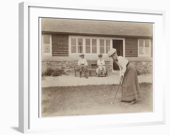 Lady Golfer Prepares to Putt as Two Seated Spectators Watch-null-Framed Photographic Print