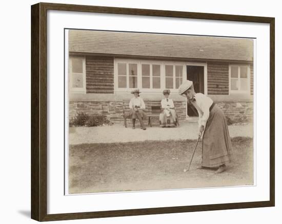 Lady Golfer Prepares to Putt as Two Seated Spectators Watch-null-Framed Photographic Print