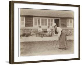 Lady Golfer Prepares to Putt as Two Seated Spectators Watch-null-Framed Photographic Print