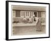 Lady Golfer Prepares to Putt as Two Seated Spectators Watch-null-Framed Photographic Print