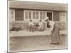 Lady Golfer Prepares to Putt as Two Seated Spectators Watch-null-Mounted Photographic Print