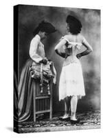 Lady Tries on a Corset While Another Woman Waits with Another One-null-Stretched Canvas