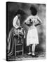 Lady Tries on a Corset While Another Woman Waits with Another One-null-Stretched Canvas