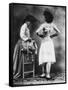 Lady Tries on a Corset While Another Woman Waits with Another One-null-Framed Stretched Canvas