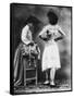 Lady Tries on a Corset While Another Woman Waits with Another One-null-Framed Stretched Canvas