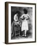 Lady Tries on a Corset While Another Woman Waits with Another One-null-Framed Photographic Print