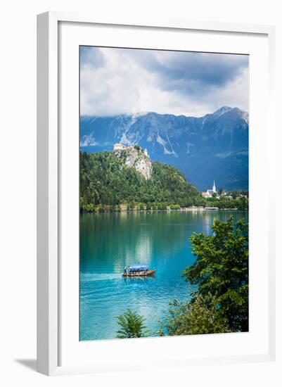Lake Bled, Upper Carniola, Slovenia. Bled Castle seen across the lake. The town of Bled in the b...-null-Framed Photographic Print