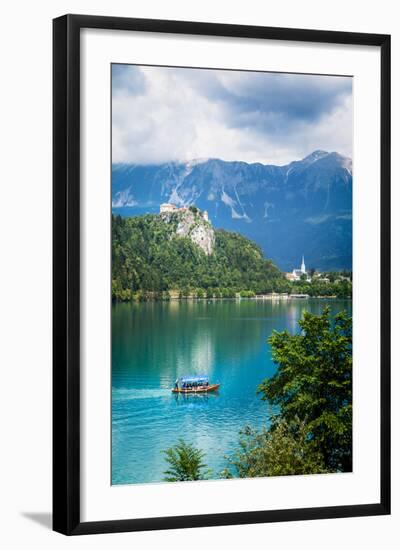 Lake Bled, Upper Carniola, Slovenia. Bled Castle seen across the lake. The town of Bled in the b...-null-Framed Photographic Print