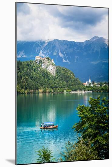 Lake Bled, Upper Carniola, Slovenia. Bled Castle seen across the lake. The town of Bled in the b...-null-Mounted Photographic Print