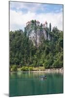 Lake Bled, Upper Carniola, Slovenia. Bled Castle seen across the lake. Tourists enjoying boating...-null-Mounted Photographic Print