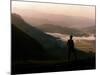 Lake District Dawn Rises in a Lakeland Pass Watched by Man in Hat-null-Mounted Photographic Print
