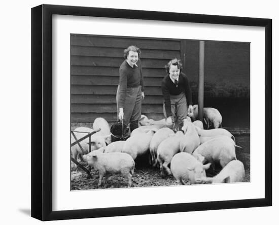 Land Girls Working Feeding Pigs on a Farm During World War II-Robert Hunt-Framed Photographic Print