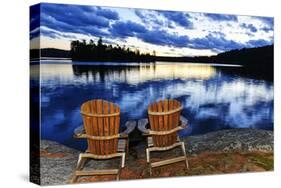 Landscape with Adirondack Chairs on Shore of Relaxing Lake at Sunset in Algonquin Park, Canada-elenathewise-Stretched Canvas