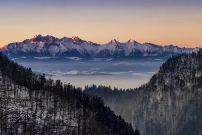 https://imgc.allpostersimages.com/img/posters/landscape-with-tatra-mountains-in-winter-at-sunset-lesser-poland-voivodeship-poland_u-L-Q1HPHGT0.jpg?artPerspective=n