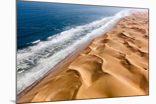Langewand, Aerial view of where the Atlantic Ocean meets the sea of dunes in Western Namibia.-ClickAlps-Mounted Photographic Print