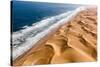 Langewand, Aerial view of where the Atlantic Ocean meets the sea of dunes in Western Namibia.-ClickAlps-Stretched Canvas