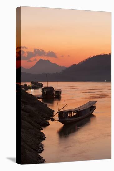 Laos, Luang Prabang, boats on Mekong River at sunset.-Merrill Images-Stretched Canvas