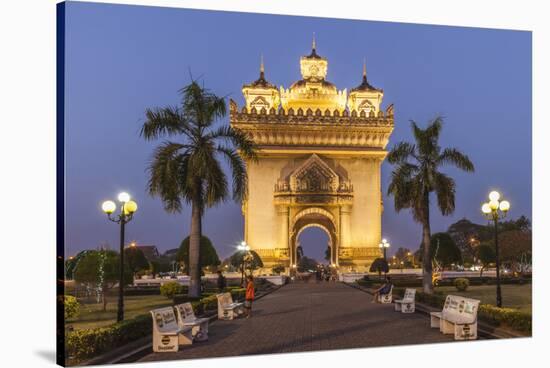 Laos, Vientiane. Patuxai, Victory Monument exterior at dusk.-Walter Bibikow-Stretched Canvas