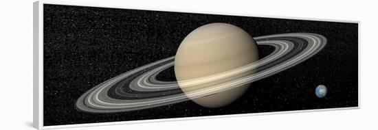 Large Planet Saturn and its Rings Next to Small Planet Earth-null-Framed Art Print