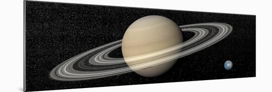 Large Planet Saturn and its Rings Next to Small Planet Earth-null-Mounted Art Print