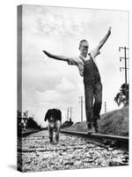 Larry Jim Holm with Dunk, His Spaniel Collie Mix, Walking Rail of Railroad Tracks in Rural Area-Myron Davis-Stretched Canvas