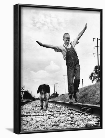 Larry Jim Holm with Dunk, His Spaniel Collie Mix, Walking Rail of Railroad Tracks in Rural Area-Myron Davis-Framed Photographic Print