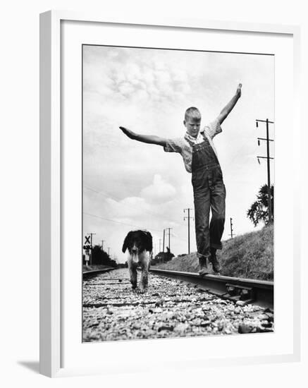 Larry Jim Holm with Dunk, His Spaniel Collie Mix, Walking Rail of Railroad Tracks in Rural Area-Myron Davis-Framed Photographic Print