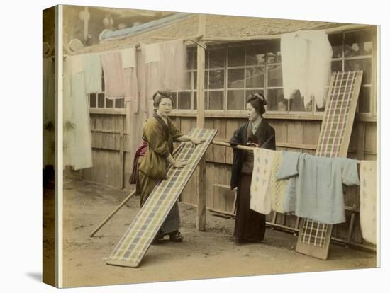 Laundry Day in Japan: Two Women Hang Up Clothes and Fabric to Dry Outdoors-null-Stretched Canvas