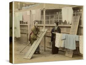 Laundry Day in Japan: Two Women Hang Up Clothes and Fabric to Dry Outdoors-null-Stretched Canvas