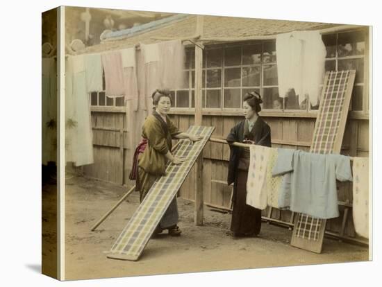 Laundry Day in Japan: Two Women Hang Up Clothes and Fabric to Dry Outdoors-null-Stretched Canvas