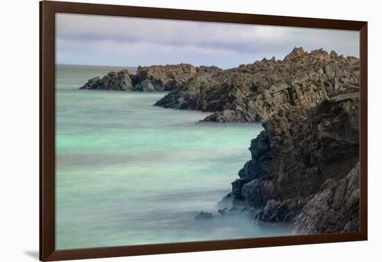 Lava rocks along tranquil shoreline of San Cristobal Island, Galapagos, Ecuador.-Adam Jones-Framed Photographic Print