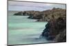 Lava rocks along tranquil shoreline of San Cristobal Island, Galapagos, Ecuador.-Adam Jones-Mounted Photographic Print