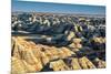 Layers of hoodoo peaks stretching into a flat landscape at the horizon.-Sheila Haddad-Mounted Photographic Print