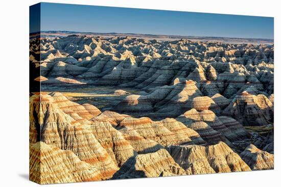 Layers of hoodoo peaks stretching into a flat landscape at the horizon.-Sheila Haddad-Stretched Canvas