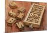 Letterpress Wood Type Blocks in a Typesetter Drawer against Rustic Red Barn Wood-PixelsAway-Mounted Art Print