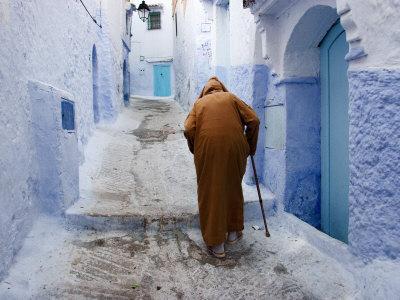 Old Man Walking in a Typical Street in Chefchaouen, Rif Mountains Region, Morocco