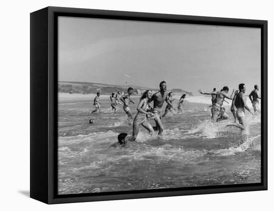 Lifeguards and Members of Womens Swimming Team Start Day by Charging into Surf-Peter Stackpole-Framed Stretched Canvas