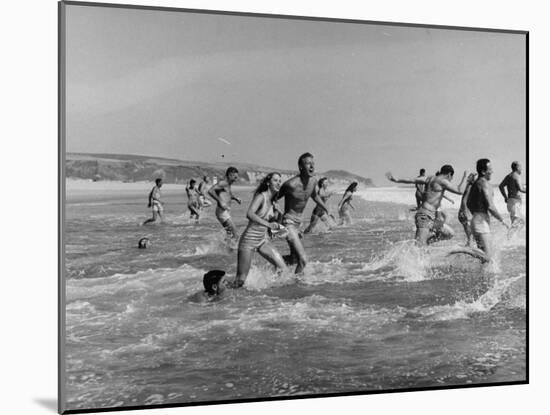 Lifeguards and Members of Womens Swimming Team Start Day by Charging into Surf-Peter Stackpole-Mounted Photographic Print