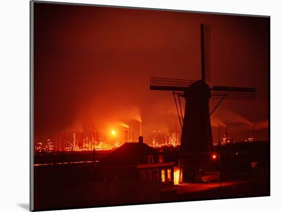 Lights and Fires of Pernis Refinery Glowing Behind Silhouetted Windmill-Ralph Crane-Mounted Photographic Print