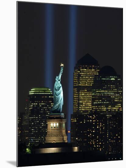 Lights from the Former World Trade Center Site Can be Seen on Both Sides of the Statue of Liberty-null-Mounted Premium Photographic Print