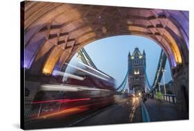 Lights on Tower Bridge over the River Thames with a typical double decker bus, London, England, Uni-Roberto Moiola-Stretched Canvas