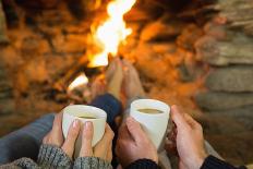 Close-Up of Hands Holding Coffee Cups in Front of Lit Fireplace-lightwavemedia-Photographic Print